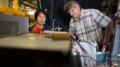 two people collaborating on a computer